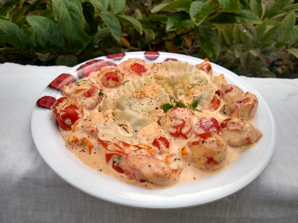 A plate of ricotta ravioli with cherry tomato sauce.