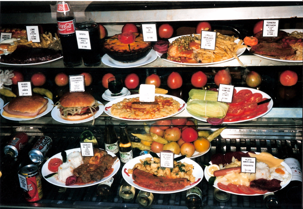 A restaurant glass display for Chilean dishes and beverages.