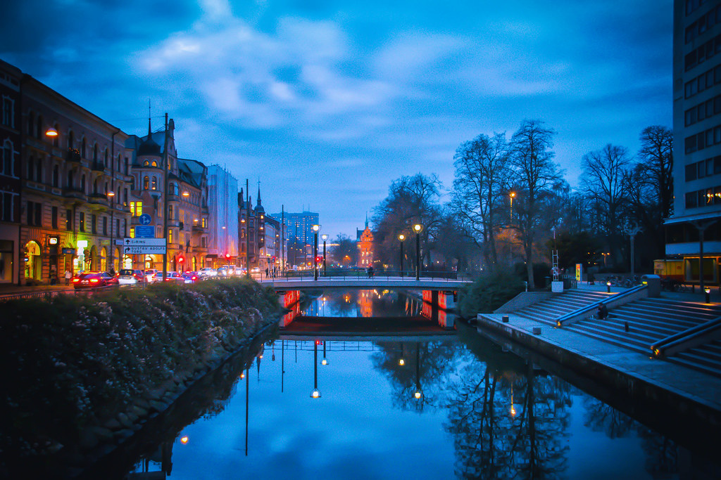 An evening image of a Malmö river and street.