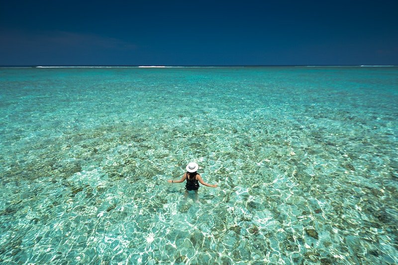 An image of a tourist swimming the waters of Belize.