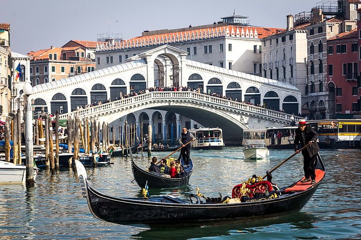 Tourists enjoying a boat ride during their senior vacation to Italy.