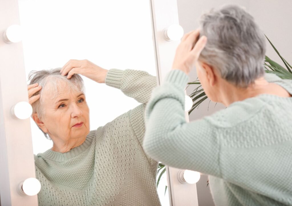 Hormonal changes reduce natural oils, leading to dryness and fragile hair.