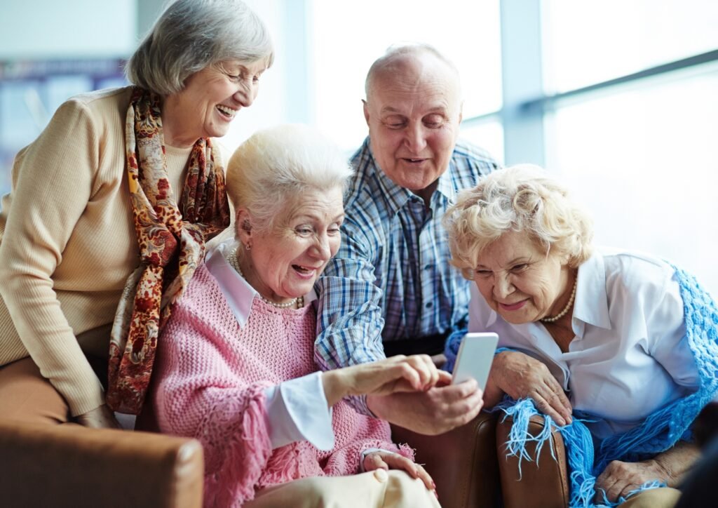 seniors looking at a phone laughing