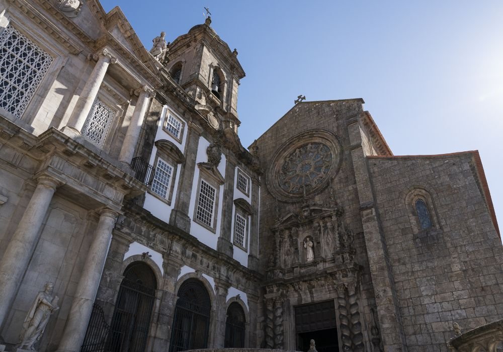 Church of São Francisco in Porto with baroque and Romanesque architecture featuring ornate stone facade and rose window