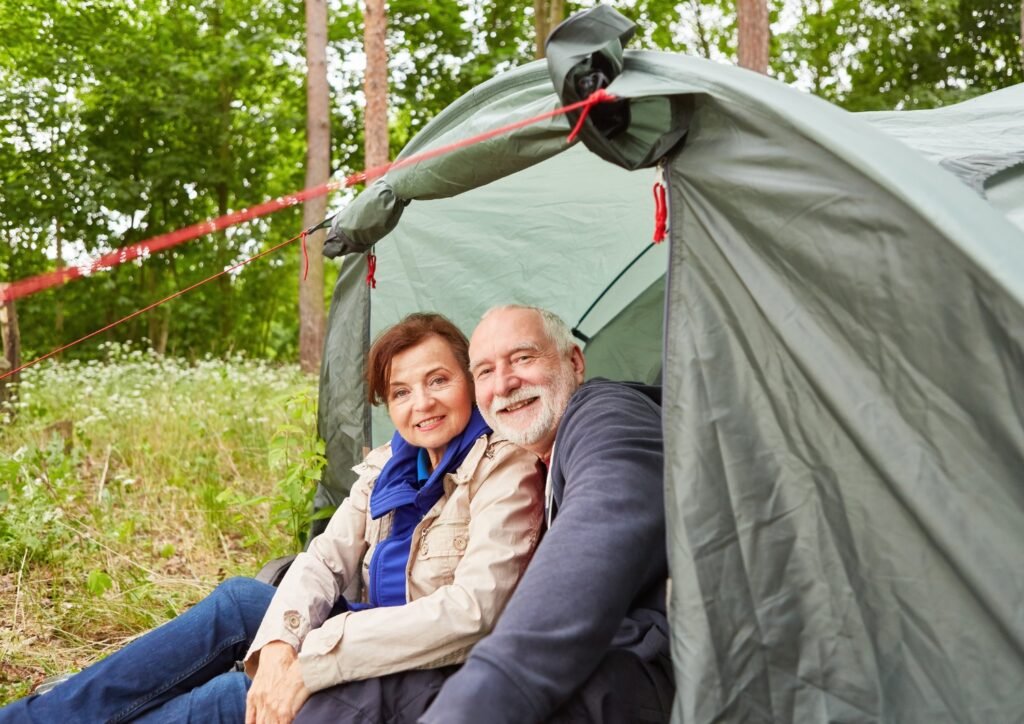 senior couple enjoying camping