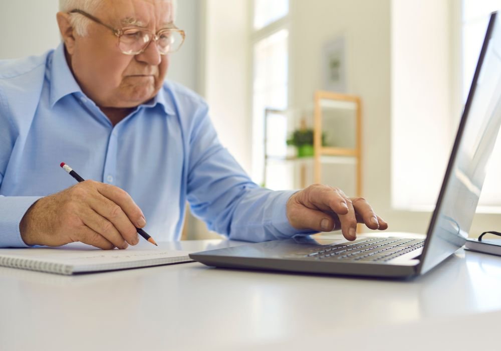 An image of a retiree learning new skills via online courses. 
