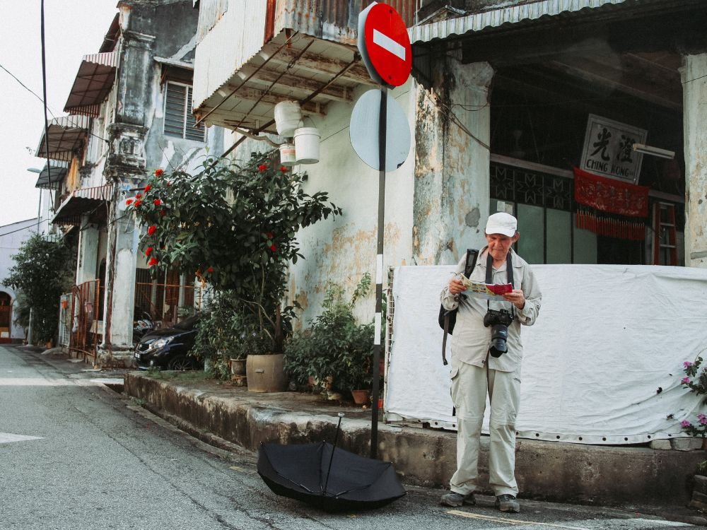 An image of an elderly reviewing his map.